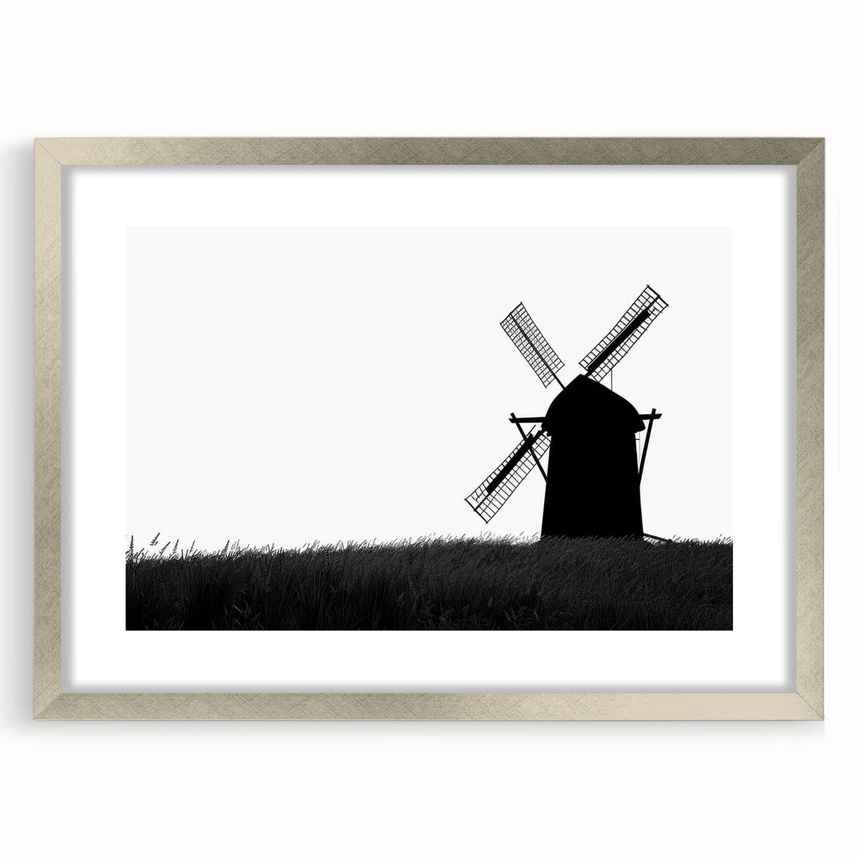 Framed wall art showcasing a picturesque landscape with windmills, featuring a sleek silver frame and mat, ideal for enhancing modern home decor.