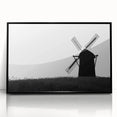 Framed acrylic wall art showcasing a stunning landscape with windmills, presented in a sleek black frame, ideal for modern home decor. Perfect for adding a touch of elegance to any room.