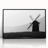 Framed acrylic wall art showcasing a stunning landscape with windmills, presented in a sleek black frame, ideal for modern home decor. Perfect for adding a touch of elegance to any room.