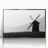 Framed acrylic wall art featuring a serene landscape with windmills, surrounded by greenery and a clear blue sky, ideal for home decor.