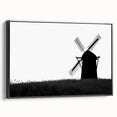 Framed canvas wall art showcasing a picturesque landscape with windmills, featuring a black frame and side view, perfect for home or office decor.