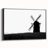 Framed canvas wall art showcasing a picturesque landscape with windmills, featuring a black frame and side view, perfect for home or office decor.