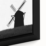 Close-up of a framed canvas wall art piece featuring a picturesque landscape with windmills, showcasing vibrant colors and intricate details, perfect for home decor.