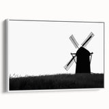 Framed canvas wall art showcasing a serene landscape with windmills against a clear blue sky, designed to add a tranquil atmosphere to home decor.