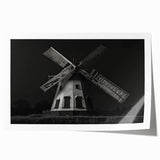 Rolled print of a serene landscape featuring windmills against a sunset backdrop, showcasing vibrant colors and intricate details, perfect for home decor.