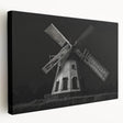 Stretched canvas wall art showcasing a serene landscape with windmills against a vibrant sunset, perfect for home decor enthusiasts seeking a tranquil ambiance.