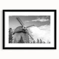 Black-framed wall art featuring a picturesque landscape with windmills, showcasing vibrant colors and intricate details, perfect for enhancing home decor.