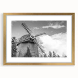 Framed wall art featuring a serene landscape with windmills, elegantly presented with a gold mat, perfect for enhancing home decor aesthetics.