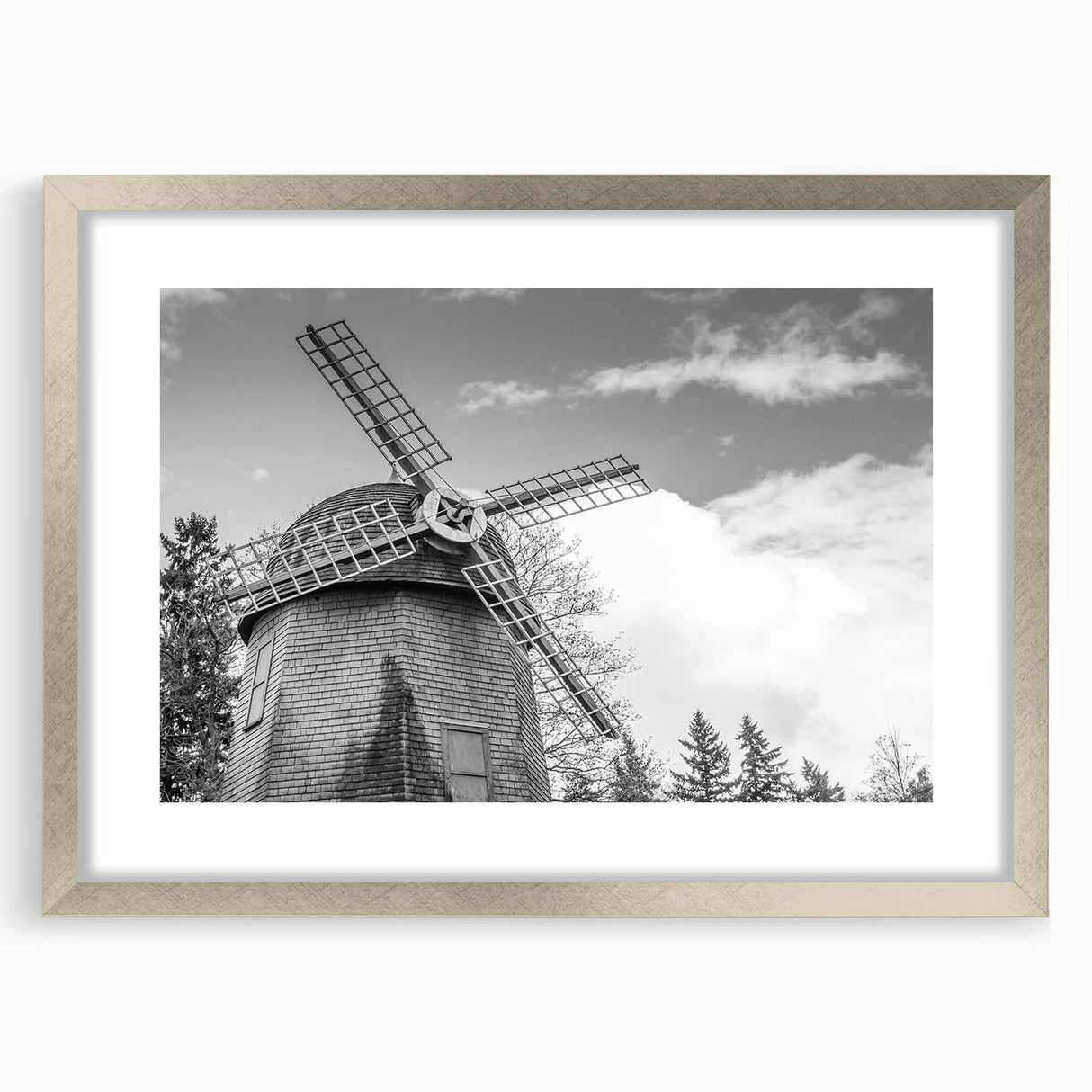 Framed wall art featuring a serene landscape with windmills, elegantly displayed with a silver mat, perfect for enhancing home decor and adding a tranquil ambiance.