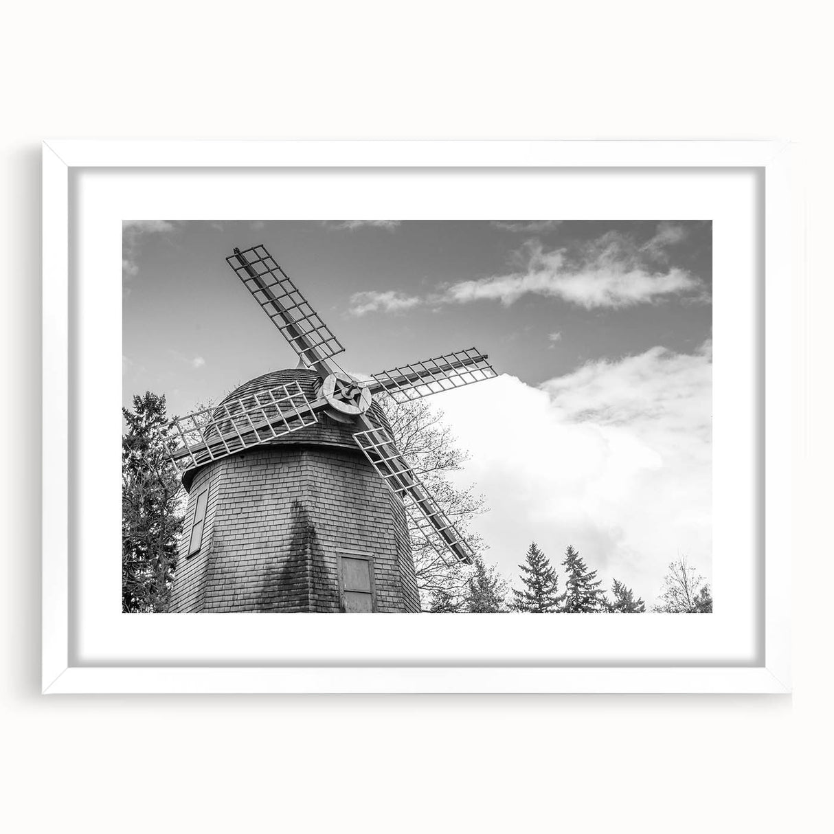 Framed landscape wall art featuring windmills against a serene sky, displayed in a white mat and frame, perfect for modern home decor and interior design.