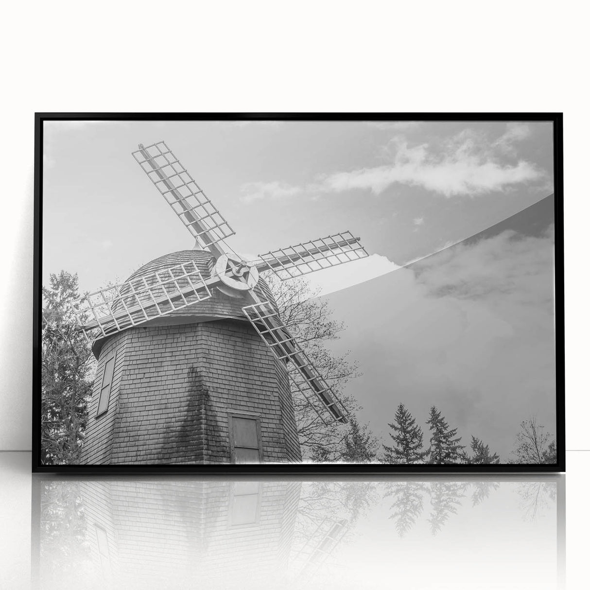 Framed wall art featuring a scenic landscape with windmills, set in a sleek black frame, showcasing vibrant colors and intricate details, ideal for home decor.