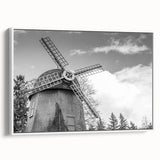 Framed canvas wall art showcasing a serene landscape with windmills under a bright blue sky, highlighting vibrant colors and detailed textures, perfect for home decor.