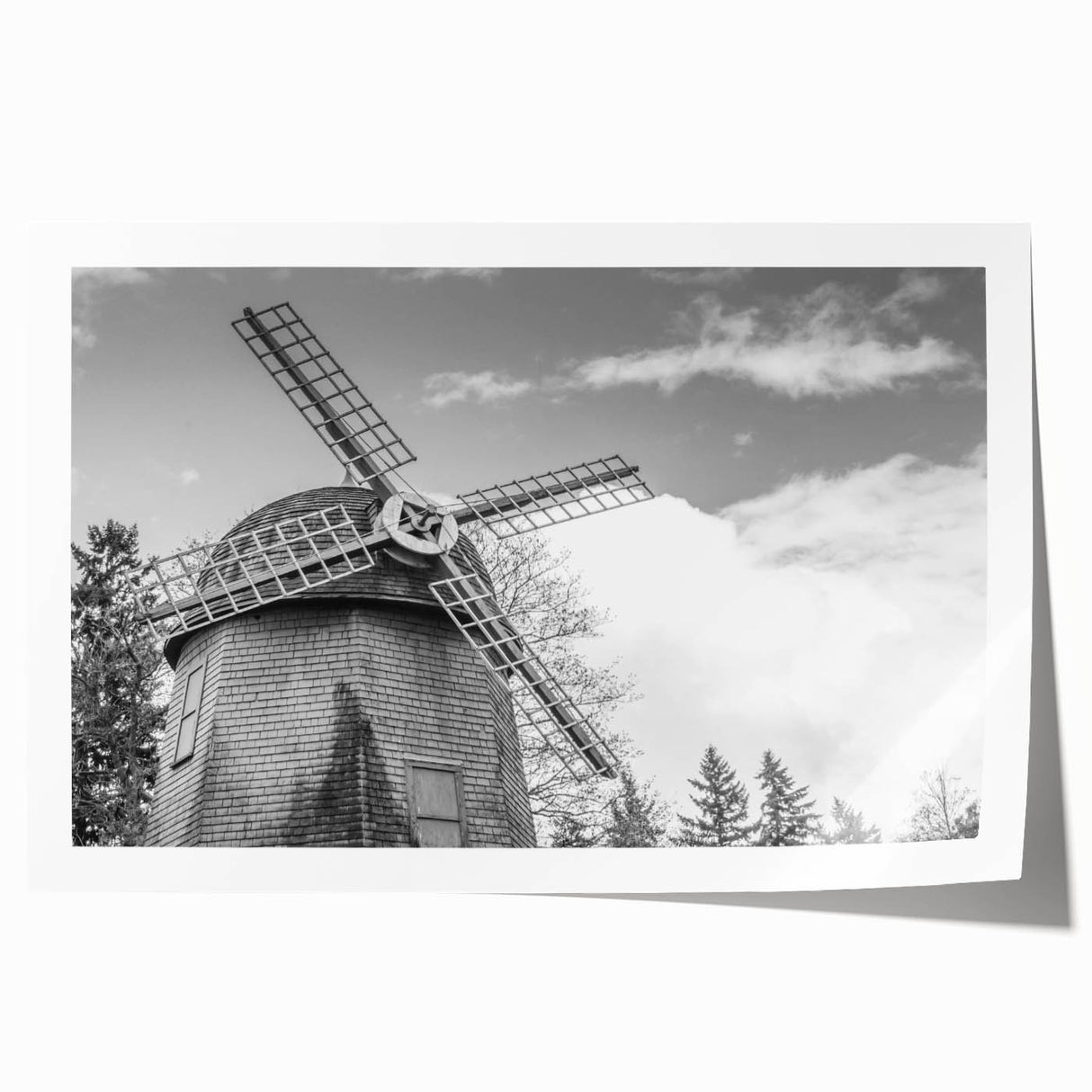 Rolled print of a serene landscape featuring windmills against a vibrant sunset sky, showcasing rich colors and intricate details, perfect for home décor.