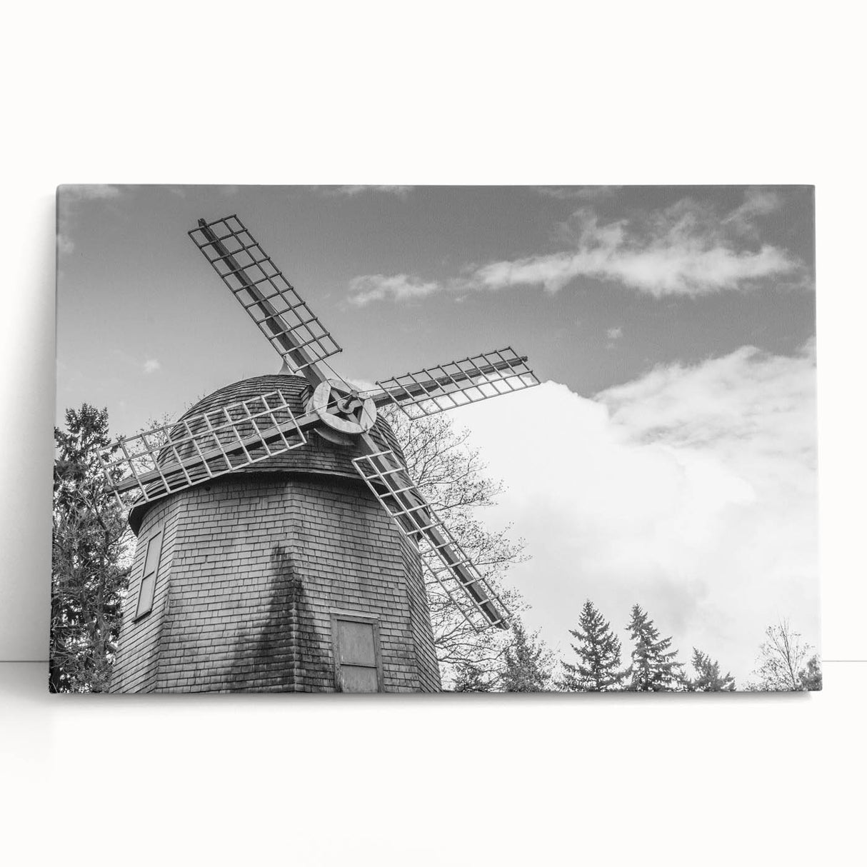 Stretched canvas wall art capturing a serene landscape with windmills, featuring soft pastel colors and a tranquil blue sky, perfect for home decor.