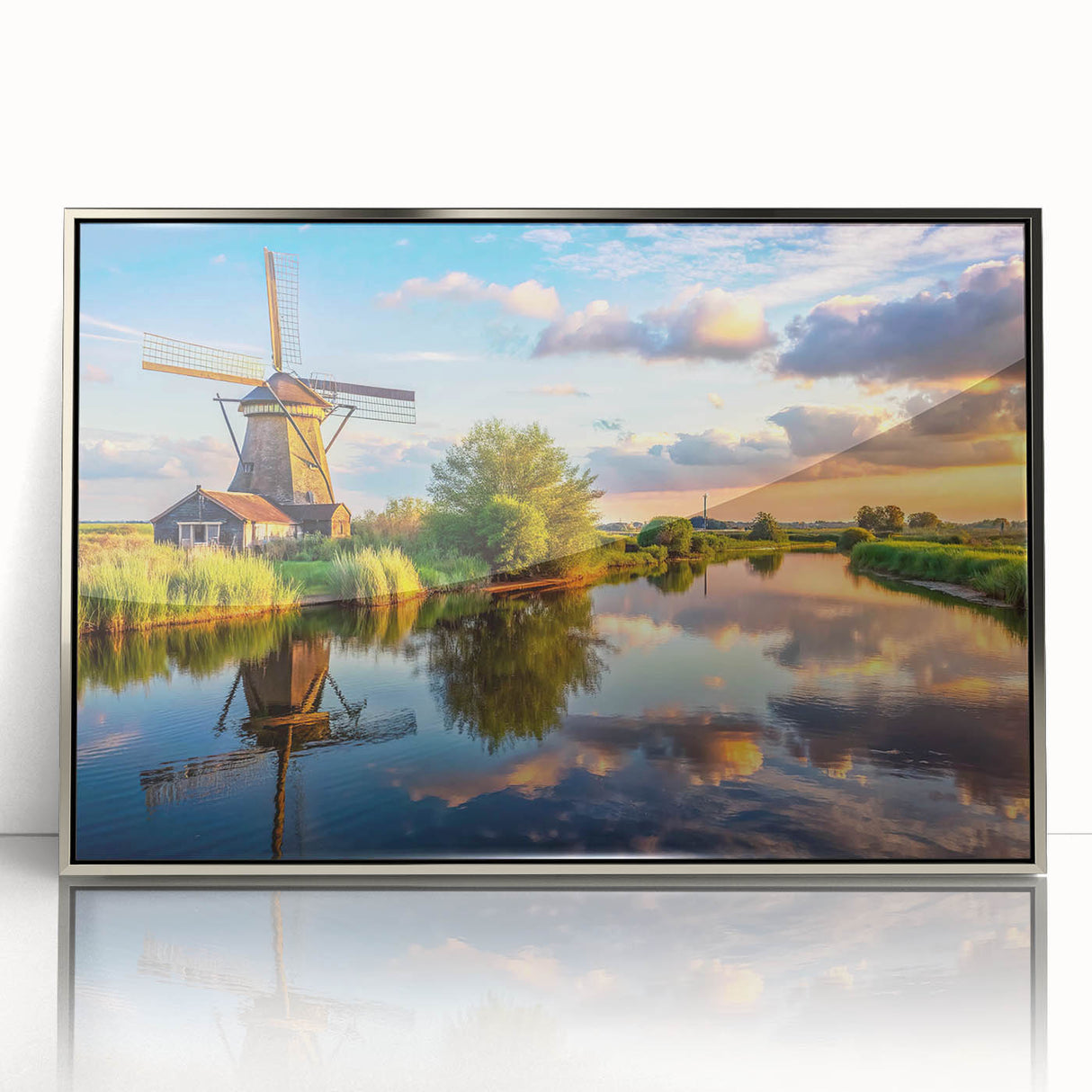Framed wall art featuring a serene landscape with windmills, displayed in an elegant silver frame, enhancing modern home decor with a tranquil ambiance.