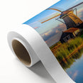 Rolled canvas artwork showcasing a vibrant landscape with windmills under a clear blue sky, perfect for enhancing home decor with a touch of nature.