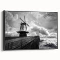 Framed canvas wall art showcasing a picturesque landscape with windmills against a vibrant sunset, featuring a sleek black frame and side view display, ideal for home decor.