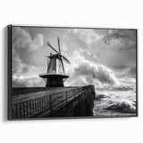 Framed canvas wall art showcasing a picturesque landscape with windmills against a vibrant sunset, featuring a sleek black frame and side view display, ideal for home decor.