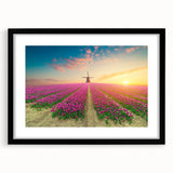 Framed wall art featuring a serene landscape with windmills, presented in a sleek black frame with a mat, ideal for enhancing home decor.