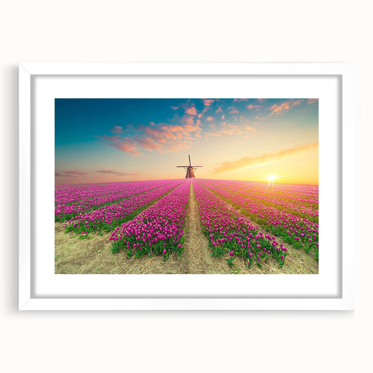 Framed wall art featuring a serene landscape of windmills against a cloudy sky. The piece includes a white mat and a sleek black frame, enhancing any modern decor.