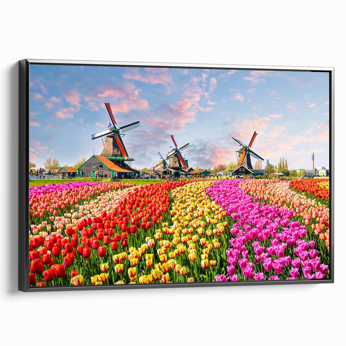 Framed canvas wall art showcasing a picturesque landscape with windmills, featuring a black frame and side view, perfect for home decor.