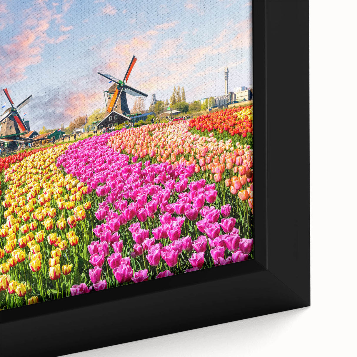 Close-up of a framed canvas depicting a serene landscape with windmills, showcasing vibrant colors and intricate details, ideal for home decor enhancement.