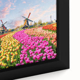 Close-up of a framed canvas depicting a serene landscape with windmills, showcasing vibrant colors and intricate details, ideal for home decor enhancement.