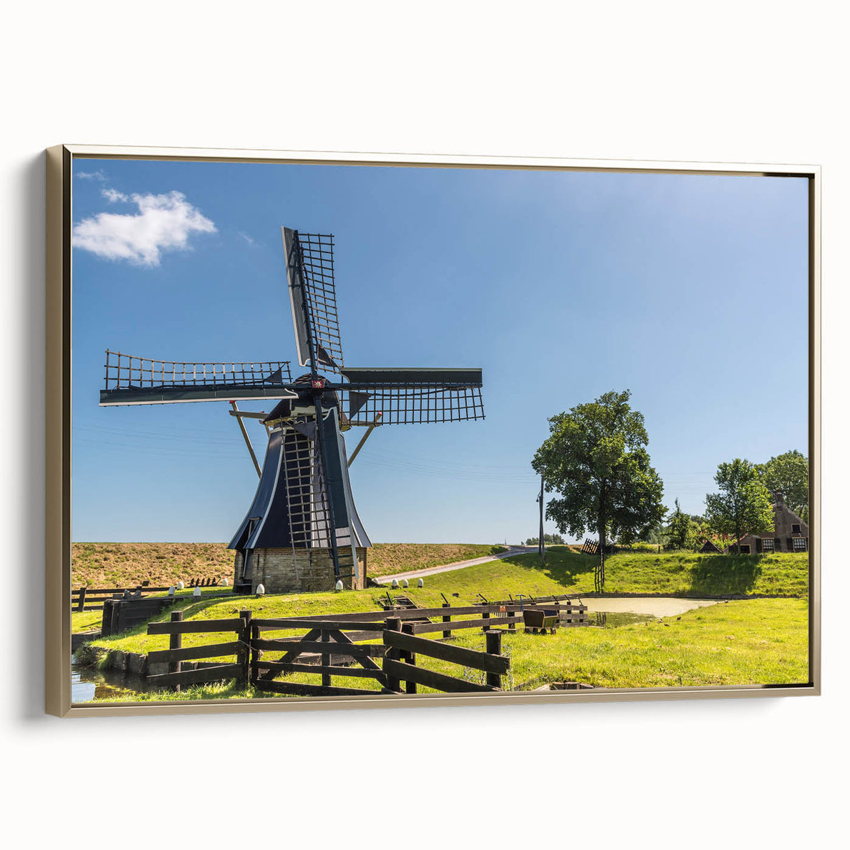 Framed canvas wall art showcasing a picturesque landscape with windmills, featuring a gold frame and vibrant colors, perfect for enhancing home decor aesthetics.