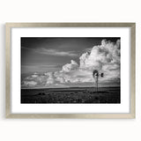 Framed landscape wall art featuring a serene windmill scene, elegantly bordered with a silver mat, perfect for enhancing modern home decor.