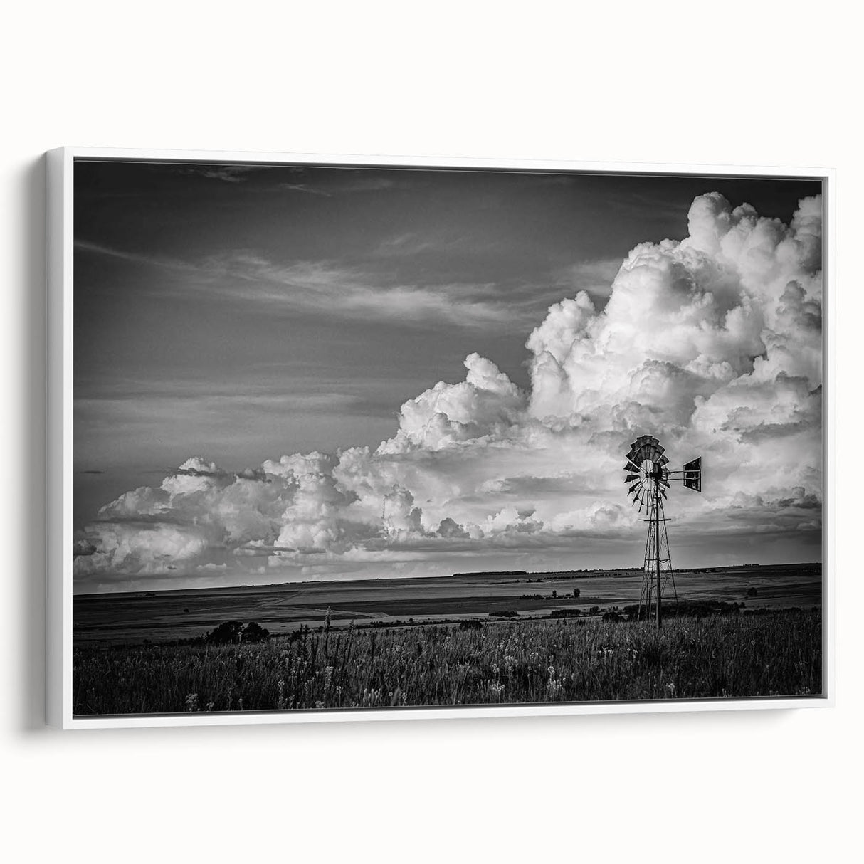 Framed canvas wall art showcasing a serene landscape with windmills, featuring a white frame and side view, perfect for enhancing home decor with a touch of elegance.