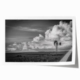 Rolled print showcasing a serene landscape with windmills, vibrant blues and greens, ideal for home decor. Comes securely packaged in a protective tube.