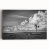 Stretched canvas wall art depicting a vibrant landscape with windmills under a blue sky, showcasing intricate details and bold colors, perfect for home decor.