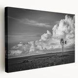 Stretched canvas artwork showcasing a vibrant landscape with windmills, featuring a colorful sunset backdrop, designed for wall decor in modern interiors.