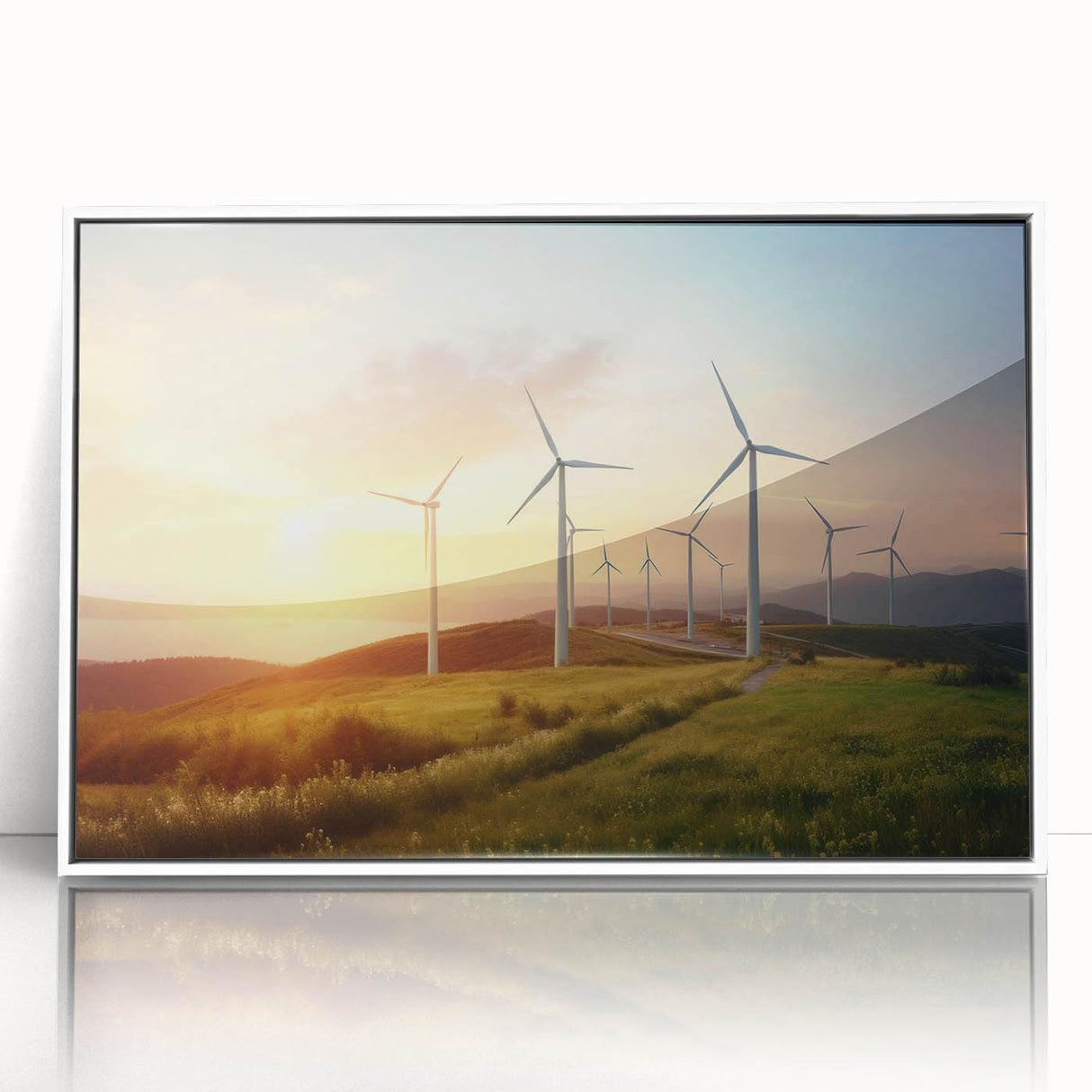 Framed wall art featuring a serene landscape with windmills, set against a vibrant sunset, showcasing a white frame that enhances the artwork's elegance.