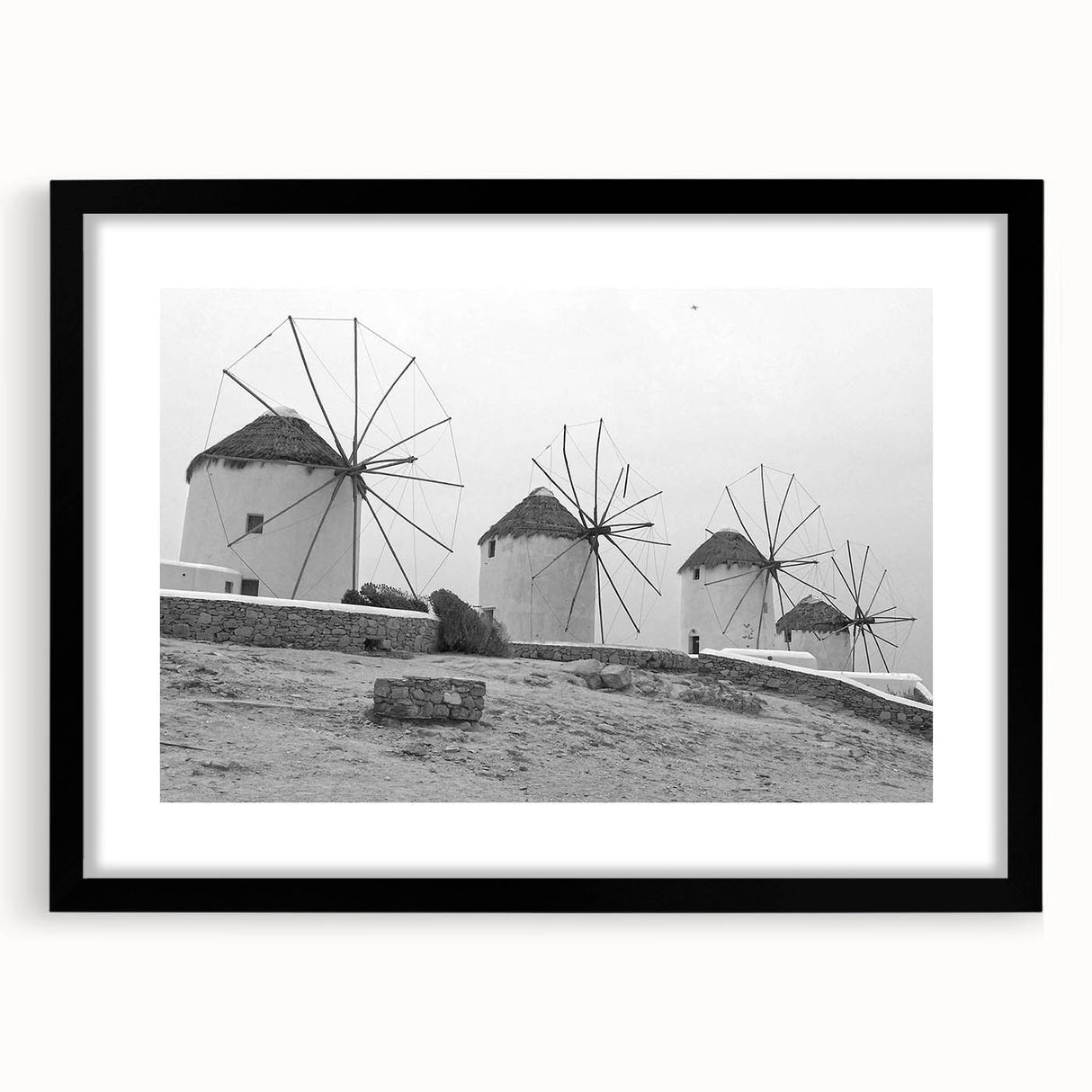 Framed wall art collection featuring a serene windmill landscape design, with a black frame and mat enhancing the visual appeal. Ideal for home decor.