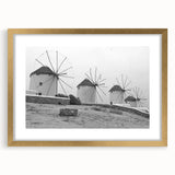 Framed wall art collection showcasing a serene landscape with windmills, featuring a gold frame and mat, perfect for enhancing modern home decor.