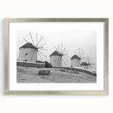 Framed wall art collection featuring a scenic landscape with windmills in a serene countryside setting, accented by a silver mat and sleek frame, ideal for home decor.