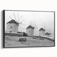 Framed canvas wall art featuring a serene landscape with windmills, showcasing vibrant colors and intricate details, set against a black frame for an elegant touch.