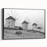 Framed canvas wall art featuring a serene landscape with windmills, showcasing vibrant colors and intricate details, set against a black frame for an elegant touch.