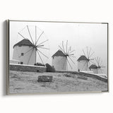 Framed canvas wall art showcasing a serene landscape with windmills, set against a soft blue sky, featuring silver accents and a modern design ideal for home decor.
