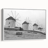 Framed wall art featuring a serene landscape with windmills, displayed against a white backdrop, ideal for home decor. The canvas design highlights soft colors and intricate details, enhancing any living space.