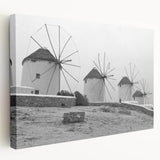 Stretched canvas wall art showcasing a serene landscape with windmills against a vibrant sunset, perfect for adding a tranquil touch to home decor.