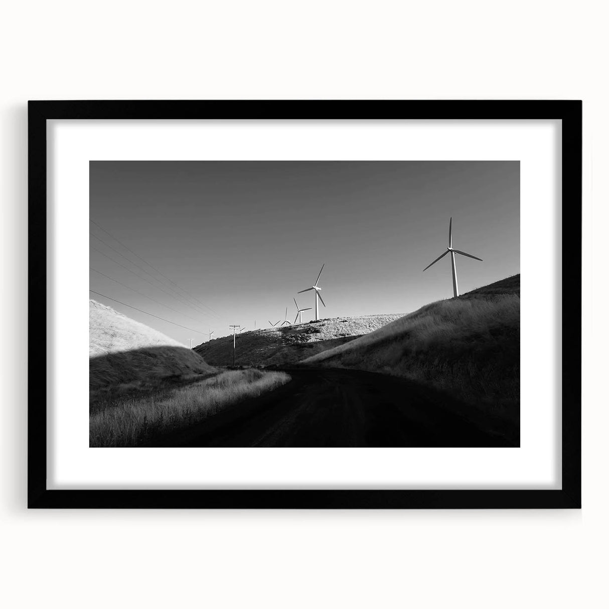 Framed wall art collection showcasing a serene landscape with windmills, featuring a black mat and sleek black frame, perfect for home decor and aesthetic enhancement.
