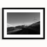 Framed wall art collection showcasing a serene landscape with windmills, featuring a black mat and sleek black frame, perfect for home decor and aesthetic enhancement.