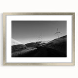 Framed wall art collection featuring a serene landscape with windmills, presented in a silver frame with a mat, ideal for enhancing home decor.