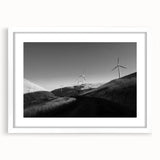 Framed wall art collection showcasing serene landscapes with windmills, presented in a sleek white frame with a mat for an elegant finish. Perfect for home decor.