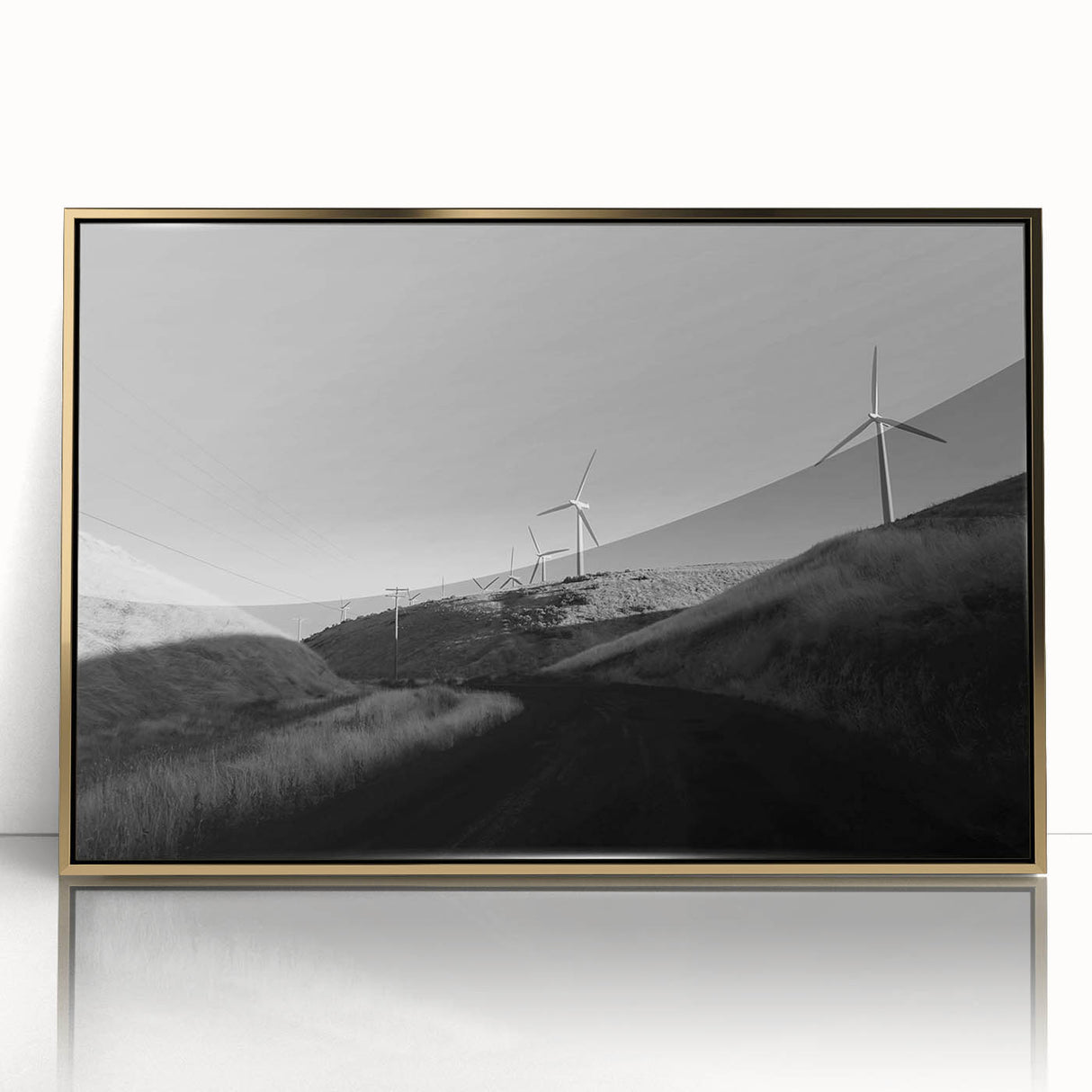 Framed wall art featuring a stunning landscape with windmills, designed in gold accents. The piece showcases a serene rural scene, perfect for home decor.