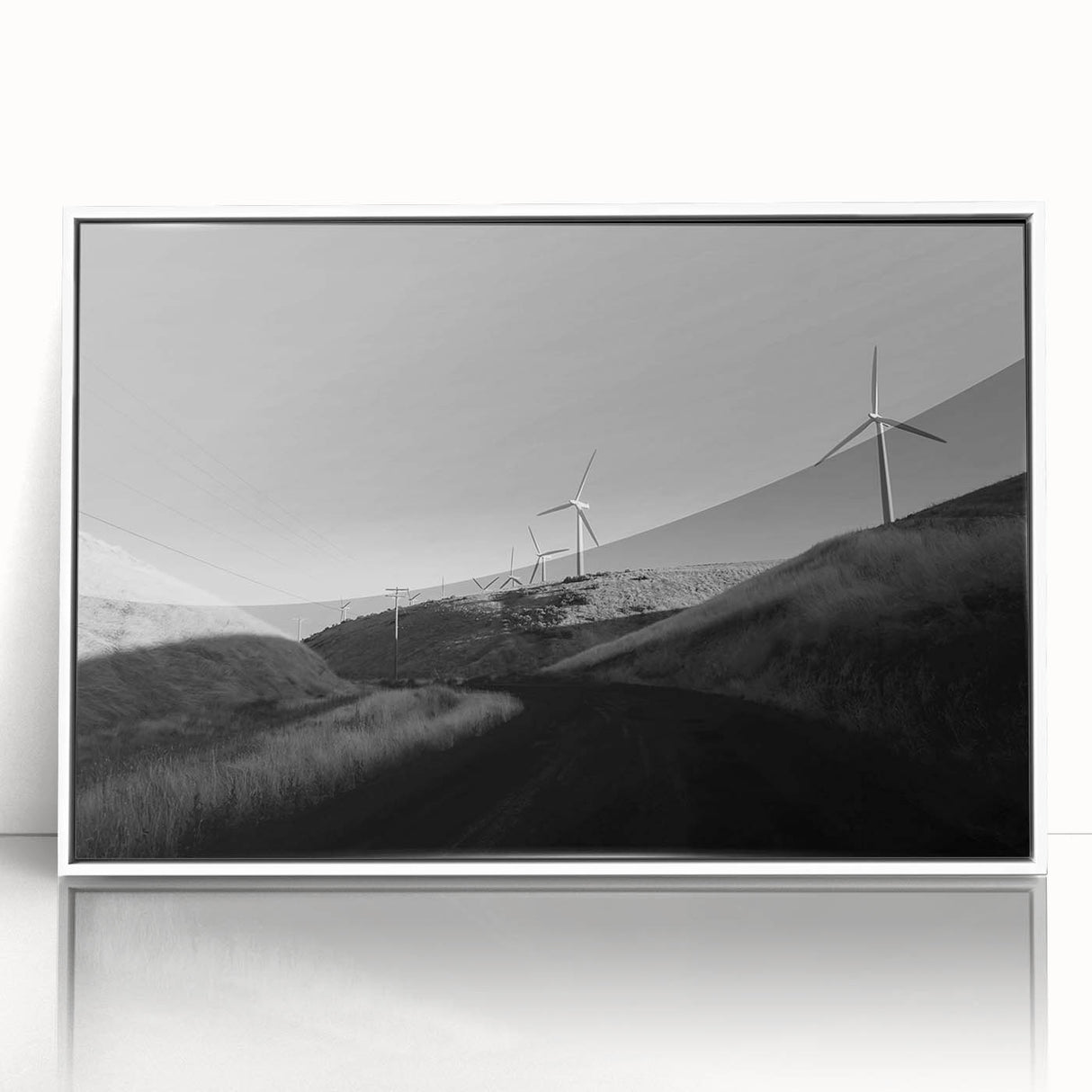 Framed wall art collection featuring a serene landscape with windmills, presented in a stylish white frame, ideal for home décor enhancement.