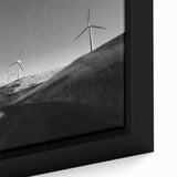 Close-up of a framed canvas wall art piece showcasing a serene landscape with windmills, featuring vibrant colors and intricate details, perfect for home decor.