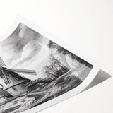 Rolled print showcasing a serene landscape with windmills against a sunset backdrop, perfect for home decor enthusiasts seeking nature-inspired wall art.
